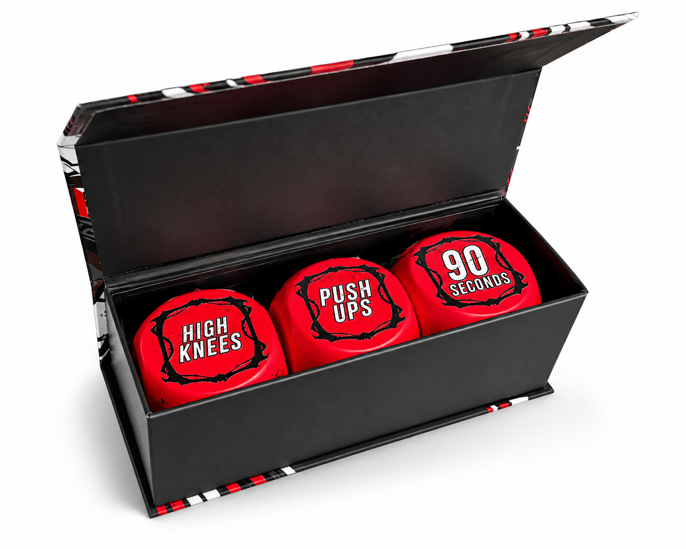 A black gift box with a patterned lid, containing three red exercise balls labeled 'HIGH KNEES', 'PUSH UPS', and '90 SECONDS'.