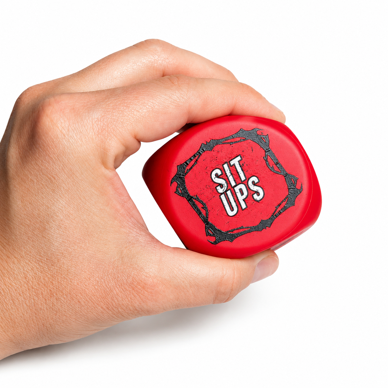A hand holding a red, sit-up exercise rollerball with 'SIT UPS' printed on it, set against a plain white background.